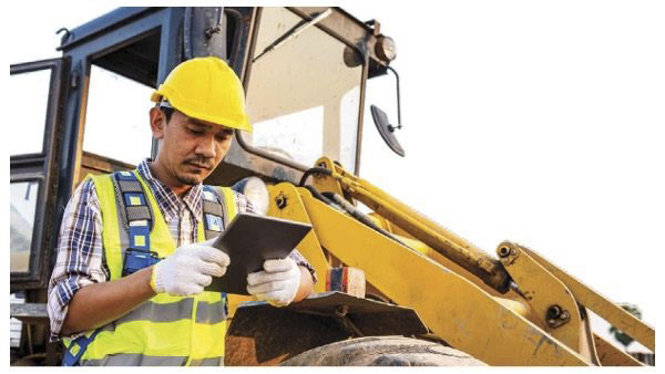 Employee wearing hard hat looking at tablet