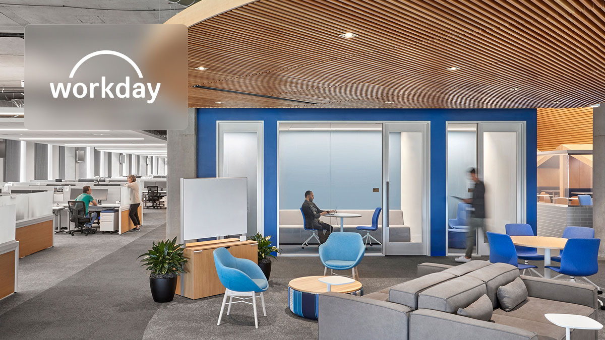 Workday logo in a modern office featuring open workstations, a meeting room, and a lounge area.